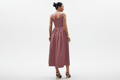 woman wearing a blush rose elegant maxi dress