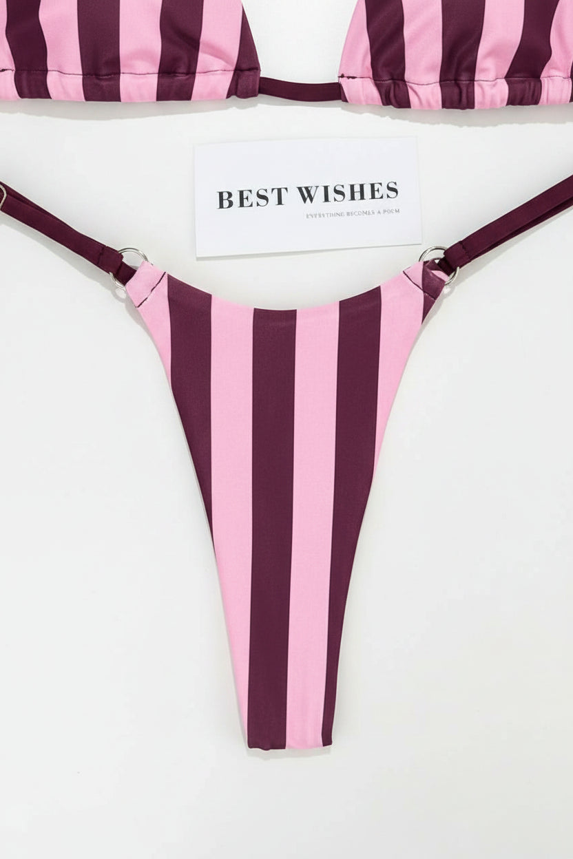 detail view of women´s swimwear with pink and burgundy lines