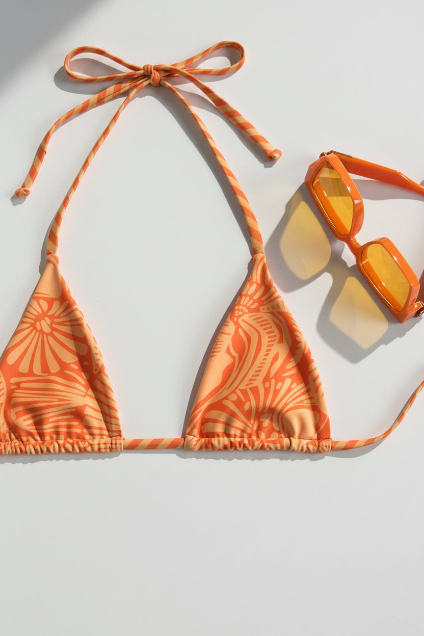 detail view of women´s swimsuit in orange with sea details