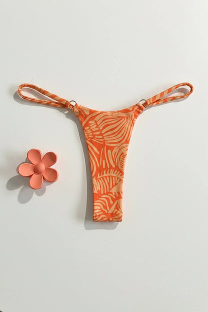 detail view of women´s swimsuit in orange with sea details