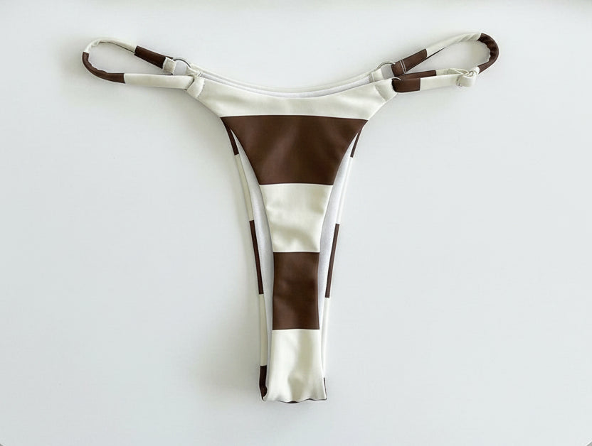 detail view of women´s swimwear in white and cocoa colors 