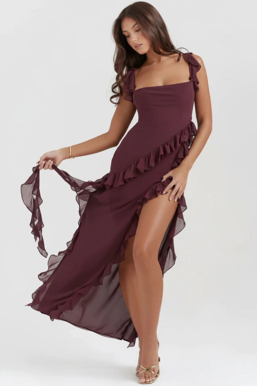 Woman wearing luxury black/burgundy slit maxi dress 