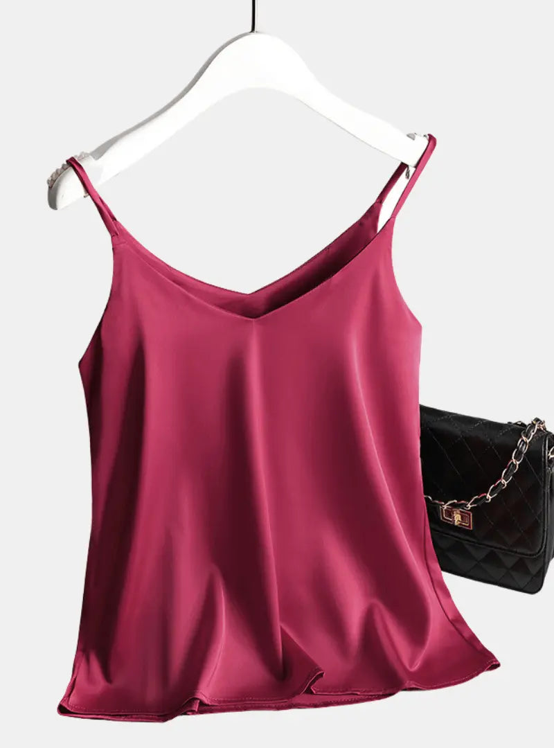 satin sleeveless crop top hanging on a clothing rack