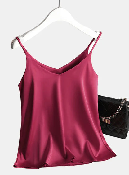 satin sleeveless crop top hanging on a clothing rack