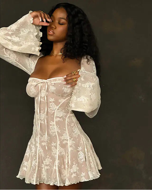 woman wearing white lace min dress with bell sleeves and A-line silhouette