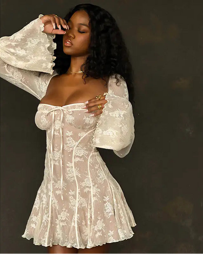 woman wearing white lace min dress with bell sleeves and A-line silhouette