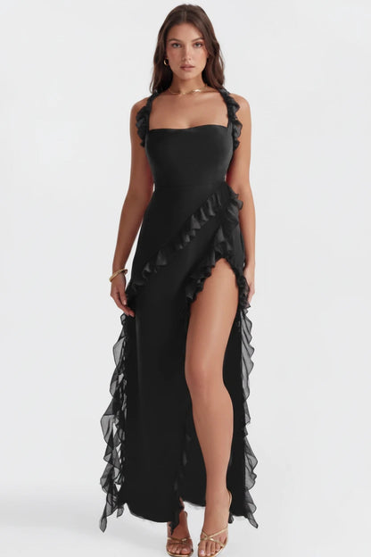 Woman wearing luxury black slit maxi dress 