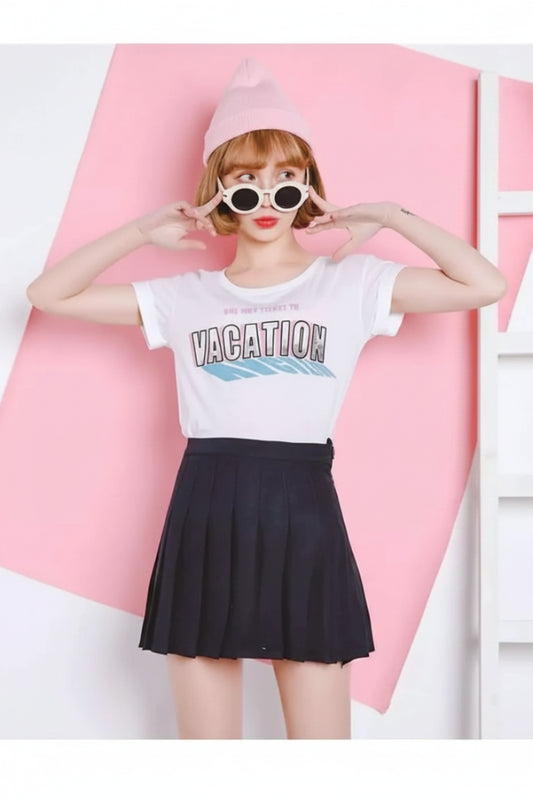 woman wearing black high-waisted A-line mini skirt with graphic t-shirt