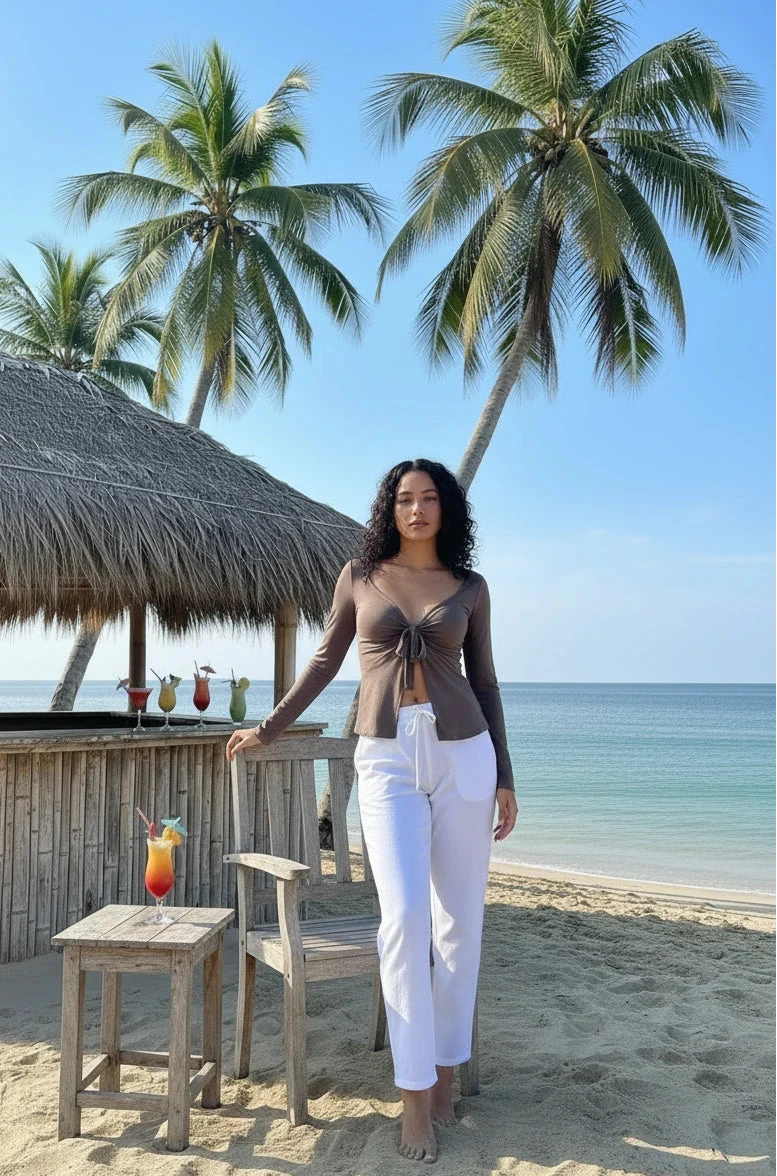 women wearing a beige long sleeve blouse and wide-leg trousers on the beach
